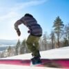 Snowboarder Riding on Rail